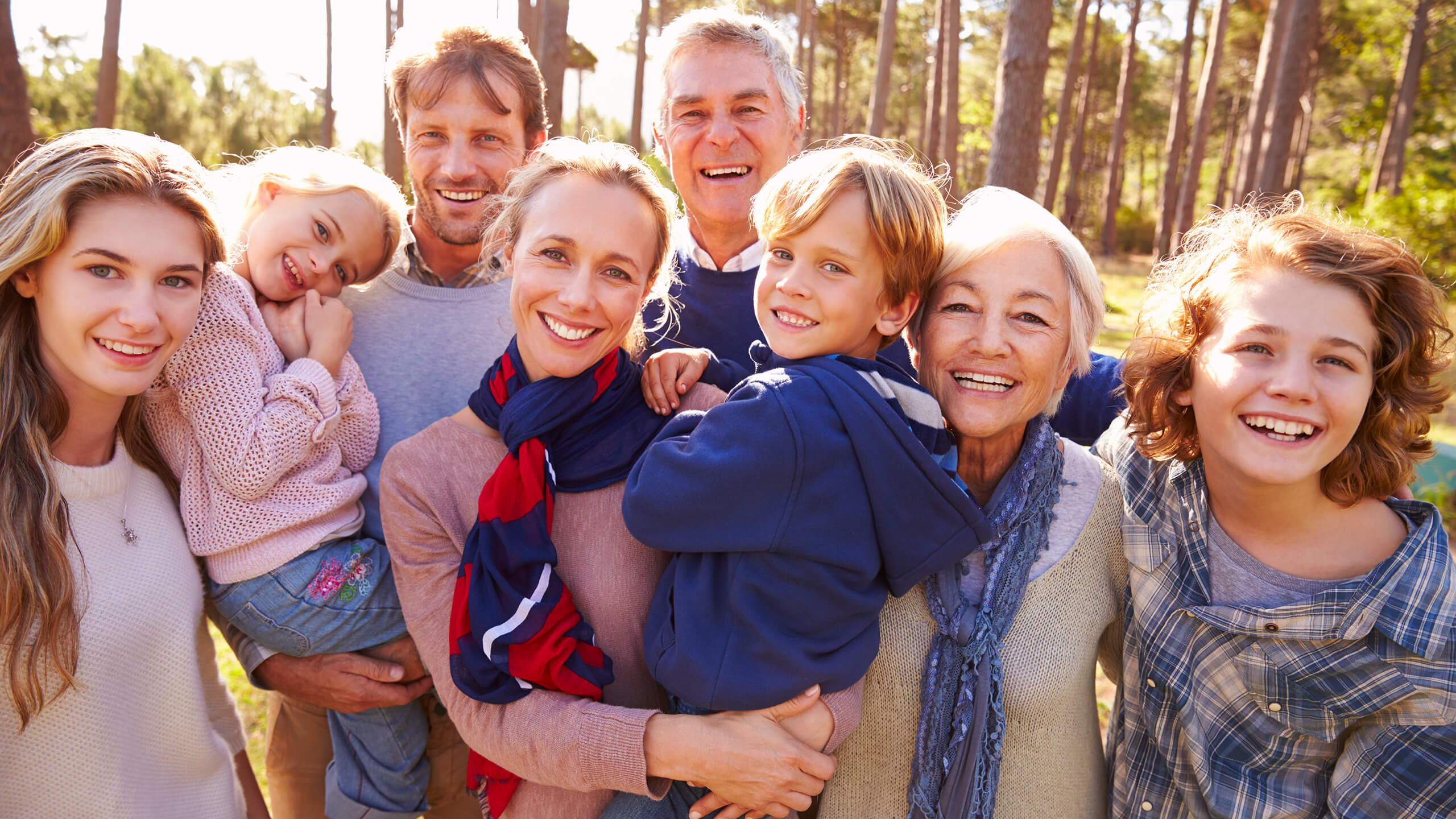 Family smiling with nature scene